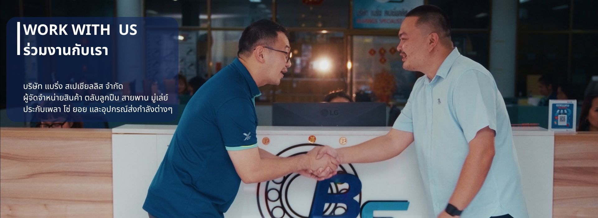 Two men shake hands in a reception area for a 'Work With Us' recruitment banner, blue overlay text on the left.