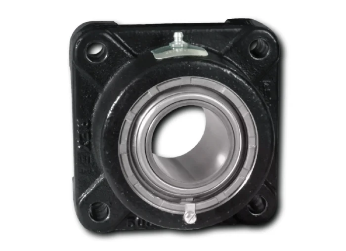 Close-up of a black bearing housing showing a circular silver inner bearing race and two mounting holes, with a small metal adjustment lever on top.