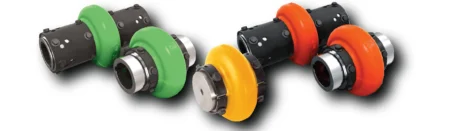 Color-coded industrial pipe couplings with bolted flanged ends, arranged in a wavy line (green, yellow, orange, red).