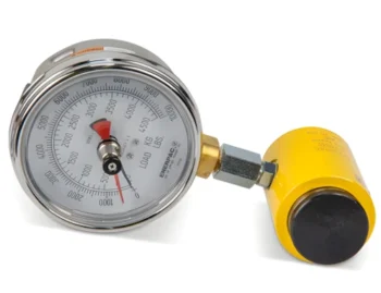 Industrial pressure gauge with chrome case and red needle, connected to a yellow air regulator.