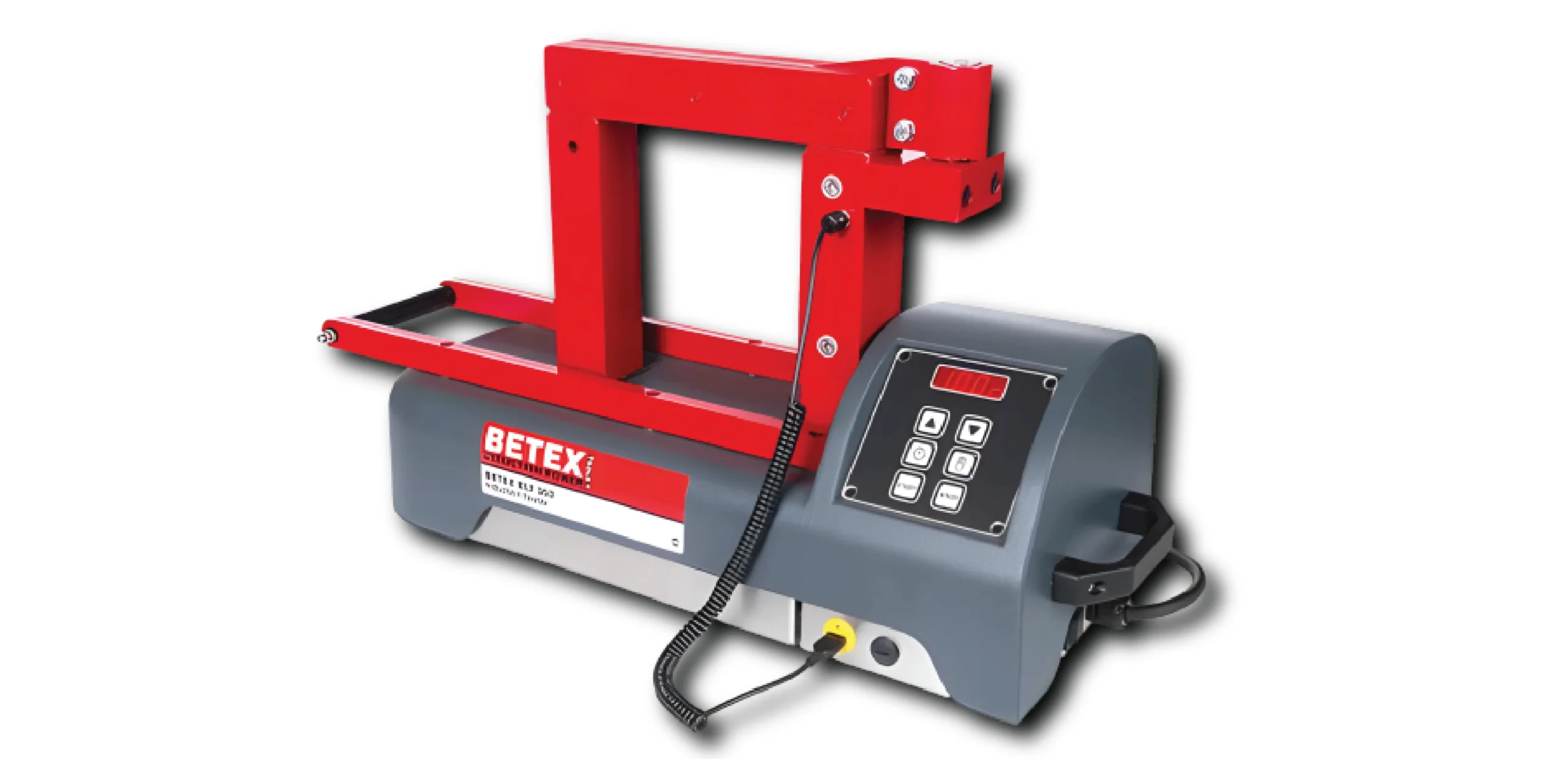 Industrial strapping tool mounted on a gray control console; red frame supports the head for securing and tensioning plastic straps, labeled BETEX on the side.