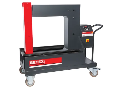 Industrial hydraulic press on a wheeled cart, red vertical pillar with a gray frame and side control panel (Betex brand).