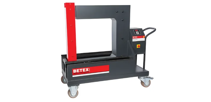 Industrial hydraulic press on a wheeled cart, red vertical pillar with a gray frame and side control panel (Betex brand).