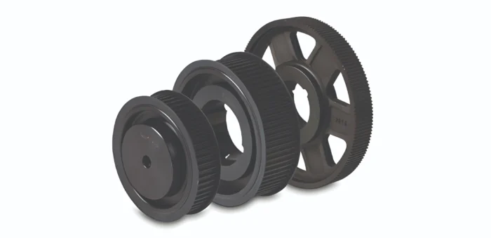 Three black toothed gears arranged in a diagonal row, part of a mechanical gear train.