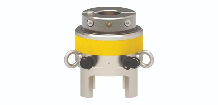 Cylindrical industrial valve or actuator with a yellow band, knurled metal top, and side handwheels on legs.