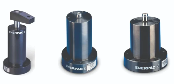 Three Enerpac hydraulic jacks lined up on a white background, blue cylinders with black bases.