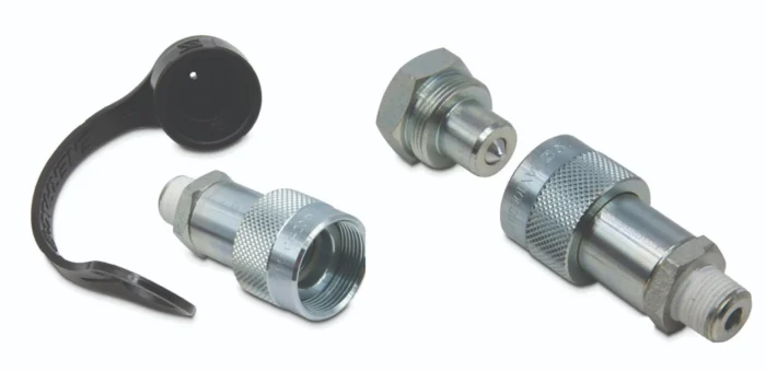 Metal hydraulic/fittings parts with knurled grips and threaded ends laid on a white background, plus a black strap nearby.