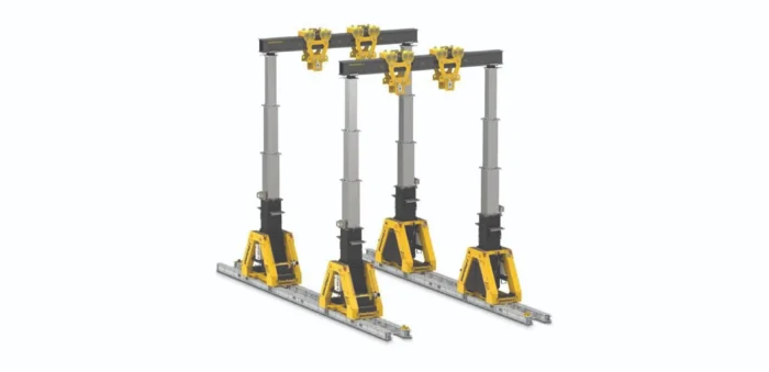 Four-post overhead gantry crane with yellow hoist trolleys on a metal beam and rails for lifting heavy loads
