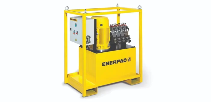 Yellow Enerpac hydraulic power unit with control panel inside a frame, mounted on a yellow base frame.